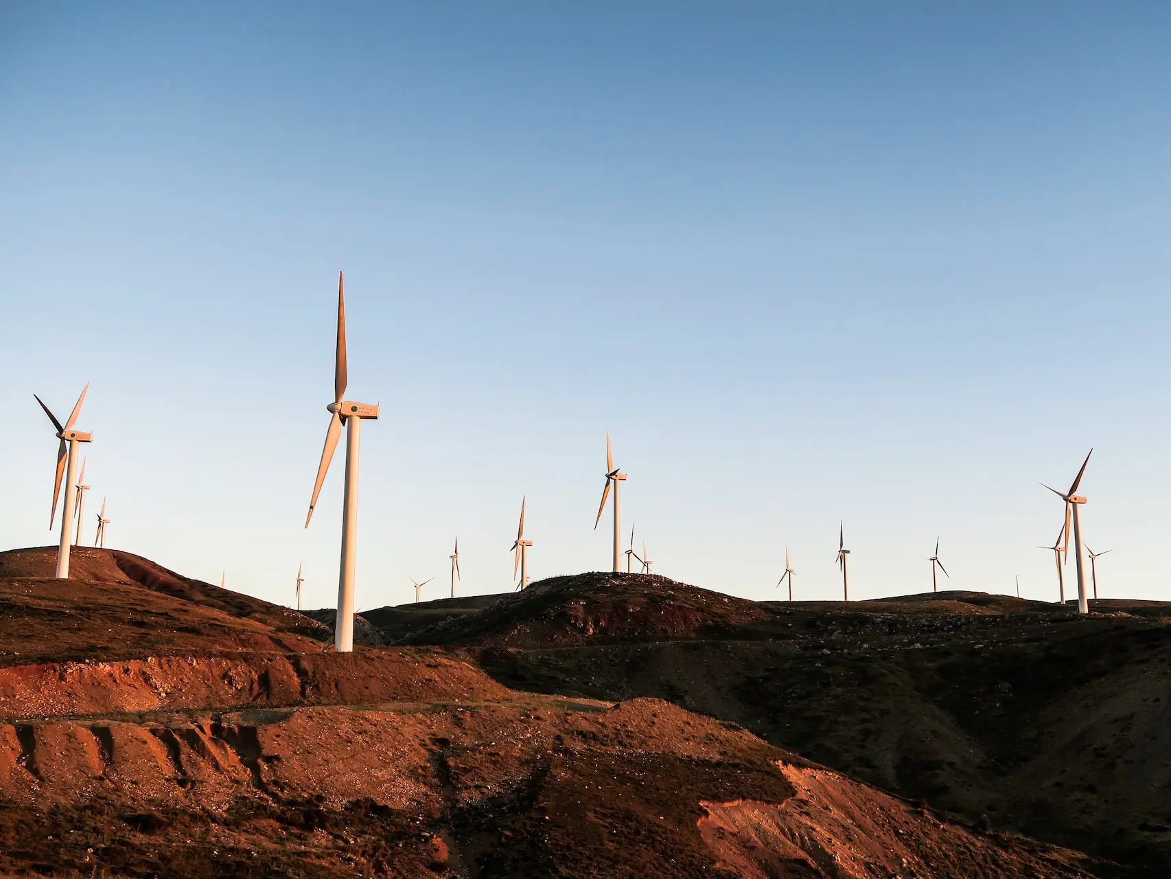 white wind turbines during daytime